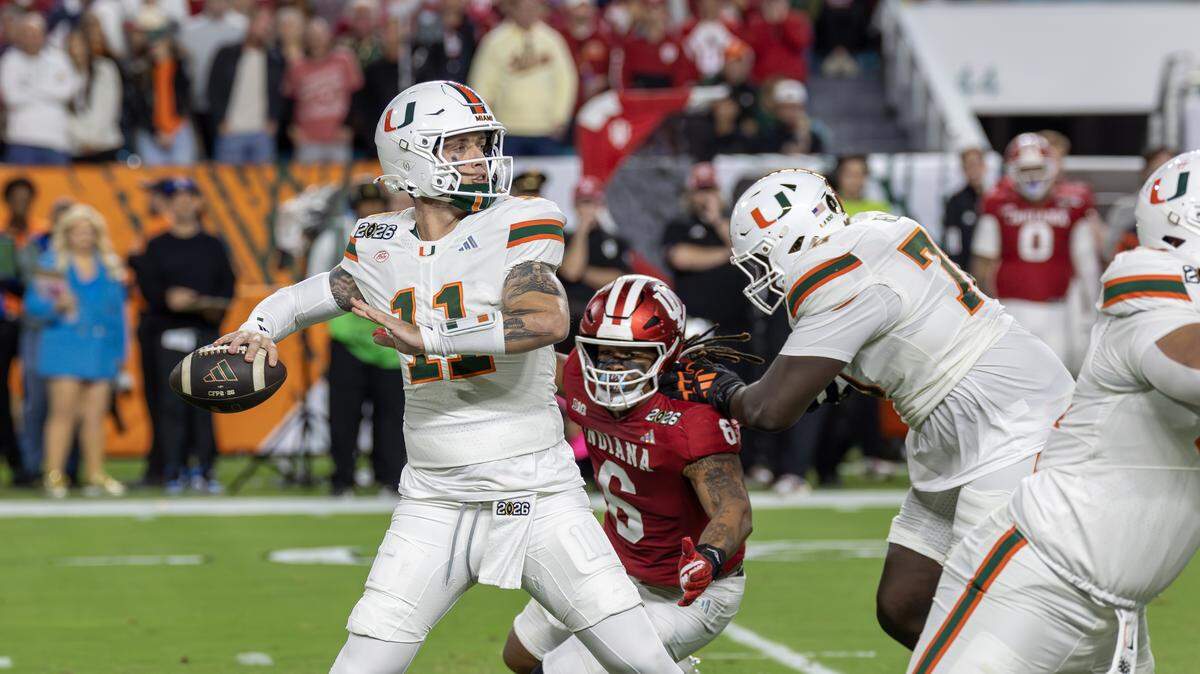 Miami Hurricanes quarterback Carson Beck (11) sets up to pass as offensive lineman Markel Bell (70) blocks Indiana Hoosiers defensive lineman Mikail Kamara (6) during the first half of the College Football Playoff national championship game Monday, Jan. 19, 2026, at Hard Rock Stadium in Miami Gardens, Fla.