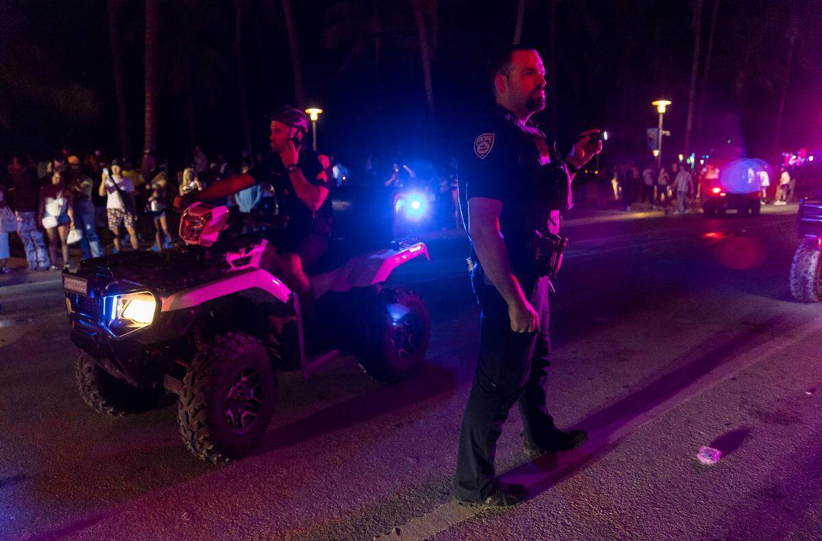 Police work to disperse a large crowd and reopen traffic on Ocean Drive during spring break on Saturday, March 11, 2023, in Miami Beach, Fla.