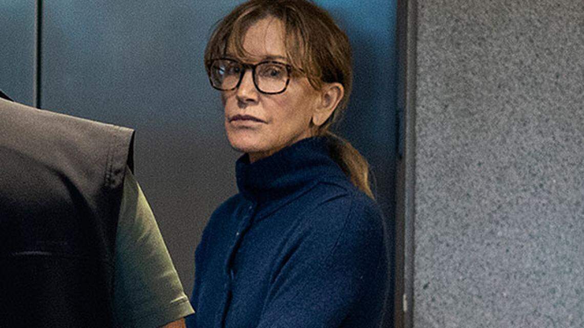 Actress Felicity Huffman stands inside the Edward R. Roybal Federal Building and U.S. Courthouse in Los Angeles, where a judge set her bail at $250,000 in the college-admissions bribery case.