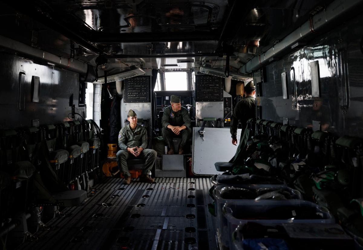 Members of a heavy marine helicopter squadron wait for people to view the CH-53K super stallion helicopter during the opening day of Fleet Week on the flight deck of the USS Bataan (LHD-5) on Monday, May 6, 2024, at Norwegian Cruise Lines Terminal in PortMiami.