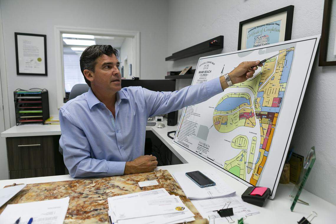Daniel Veitia, a longtime resident, property manager and broker in Miami Beach’s North Beach section, points to a zoning m of the neighborhood in his Urban Resource office in the Normandy Isle fountain district.