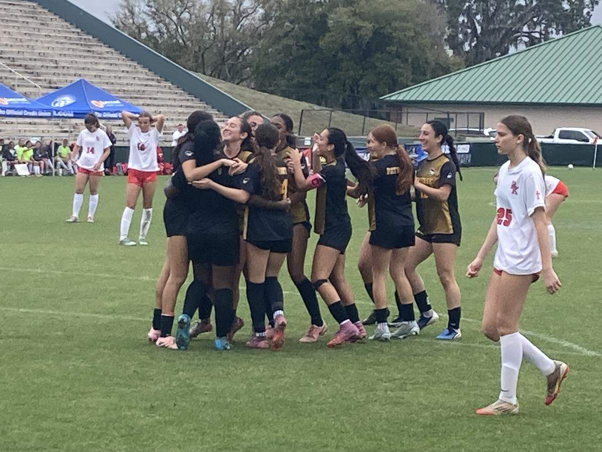 American Heritage girls’ soccer players celebrate after scoring their first goal in Saturday’s 2-0 win over Jacksonville Bishop Kenny in the Class 4A state championship game at Spec Martin Stadium in DeLand, Fla.