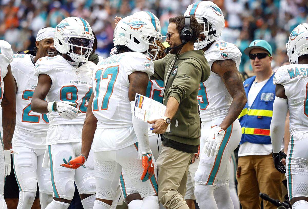 Miami Dolphins wide receiver Jaylen Waddle (17) celebrates with head coach Mike McDaniel after Waddle catches a touchdown pass in the first half of an NFL football game at Hard Rock Stadium in Miami Gardens, Florida on Sunday, November 9, 2025.