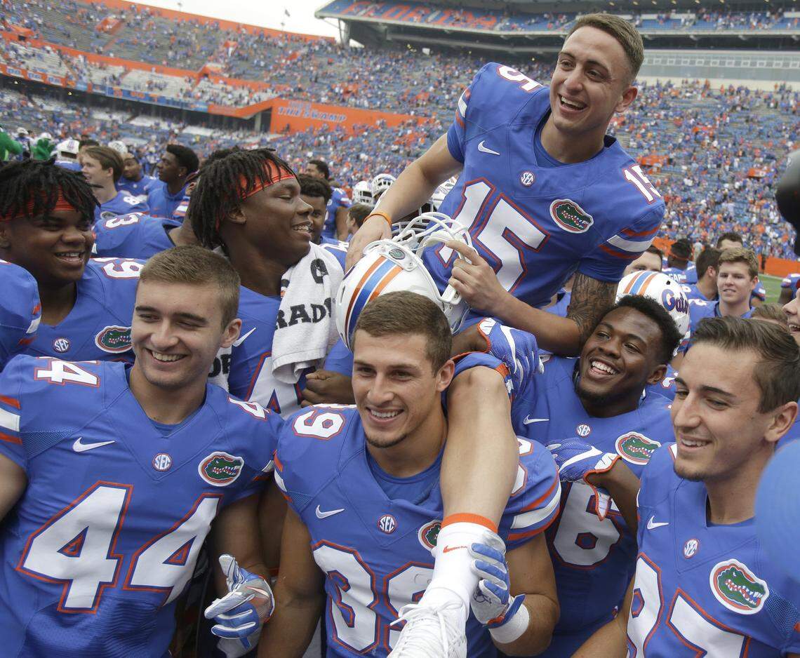 Florida place kicker Eddy Pineiro (15) sits on the shoulders of his teammates as they celebrate after defeating South Carolina 20-7 in an NCAA college football game, in Gainesville, Fla.
