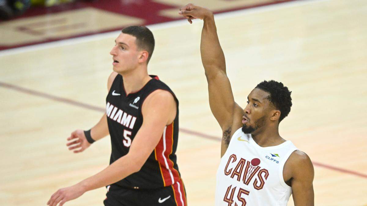 Cleveland Cavaliers guard Donovan Mitchell (45) shoots beside Miami Heat forward Nikola Jovic (5) in the fourth quarter of game two of the first round of the 2025 NBA Playoffs at Rocket Arena.