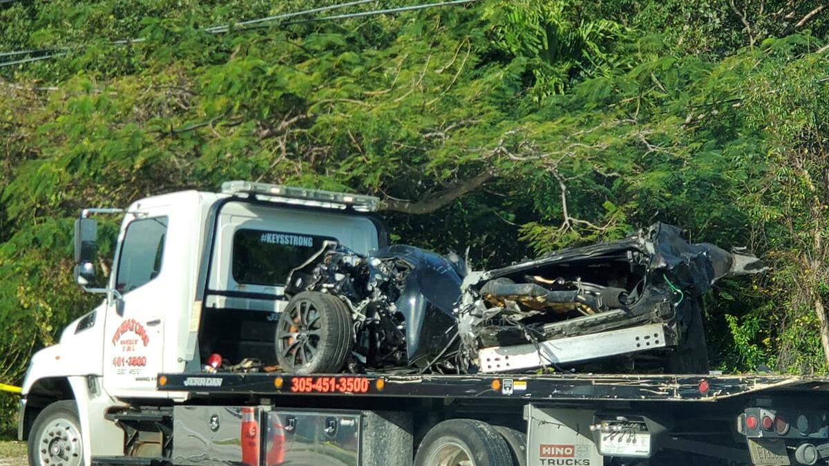 The mangled wreckage of a car sits atop the flatbed of a tow truck in Key Largo Tuesday morning, Feb. 23, 2021. The fatal crash knocked out power to 1,248 people and prompted Keys officials to close three area schools for the day.