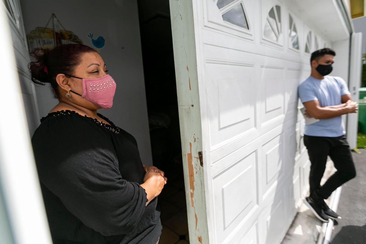Wendy Bustamante, left, and her husband, Arnold Ulloa, spend time at their home on Wednesday, March 10, 2021. Their two children, who attend Claude Pepper Elementary in West Kendall, accrued excessive absences last March after the coronavirus closed their school. A social worker from Miami-Dade Schools helped the children get back to school.
