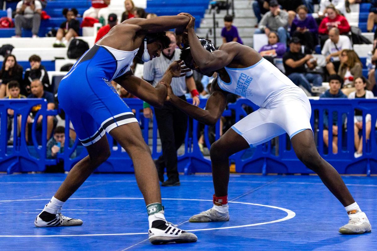 South Dade’s Lawrence Rosario wrestles Miami Palmetto’s Ronald Butler during the 2023 Boys GMAC Wrestling 170 weight class championships at South Dade Senior High School on Saturday.