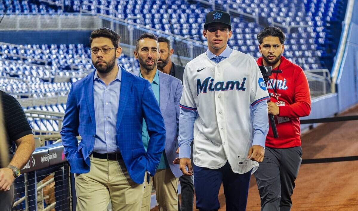 From left- Peter Bendix, President of baseball operations and Frankie Piliere, VP, Amateur Forecasting and Player Evaluation, walked with Jacob Lombard (SS), the Miami Marlins' pick from Gulliver Prep, during a presser on the field at Loandepot Park, on Thursday July 16, 2026.