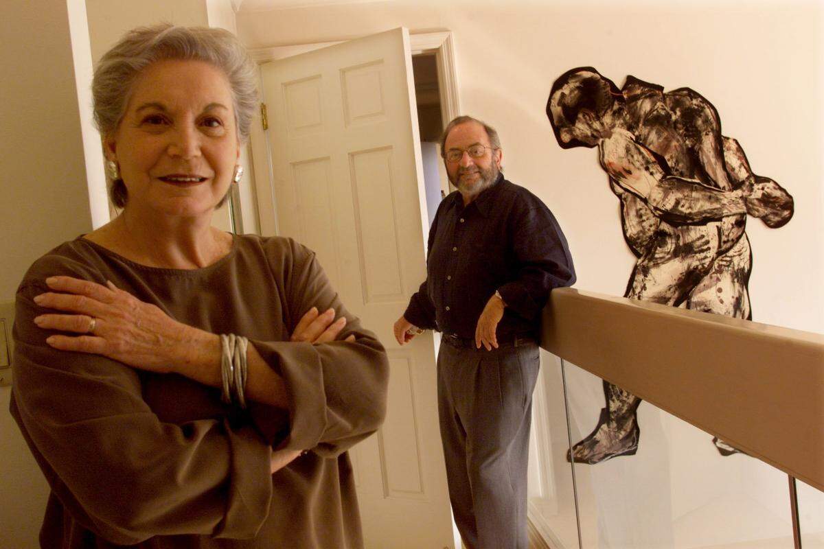 Art collectors Ruth and Richard Shack are pictured with some of their artwork at their home in 1999. In the background is “Striding Man” by William Kentridge.