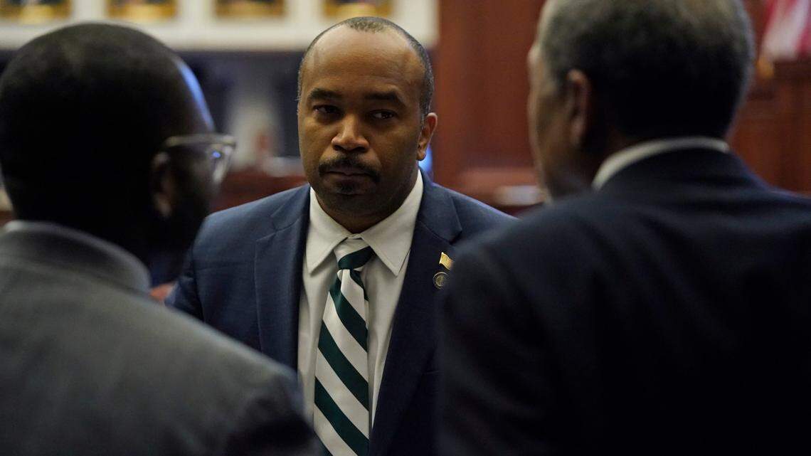 Florida Sens. Bobby Powell, center, Shevrin Jones, left, and Darryl Ervin Rouson talk during a legislative session at the Florida State Capitol.