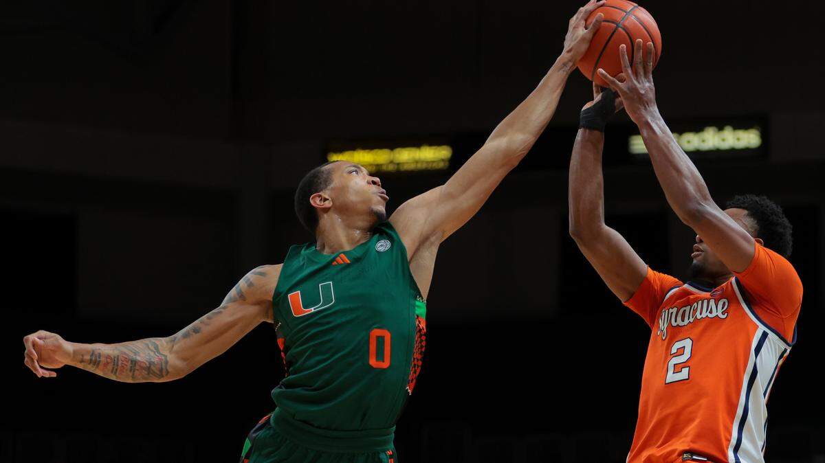 Feb 11, 2025; Coral Gables, Florida, USA; Miami Hurricanes guard Matthew Cleveland (0) blocks a shot against Syracuse Orange guard J.J. Starling (2) during the first half at Watsco Center. Mandatory Credit: Sam Navarro-Imagn Images