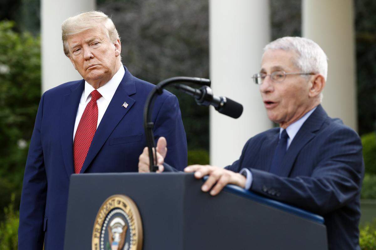 President Donald Trump listens as Dr. Anthony Fauci, director of the National Institute of Allergy and Infectious Diseases, speaks during a coronavirus task force briefing in the Rose Garden of the White House, Sunday, March 29, 2020, in Washington.