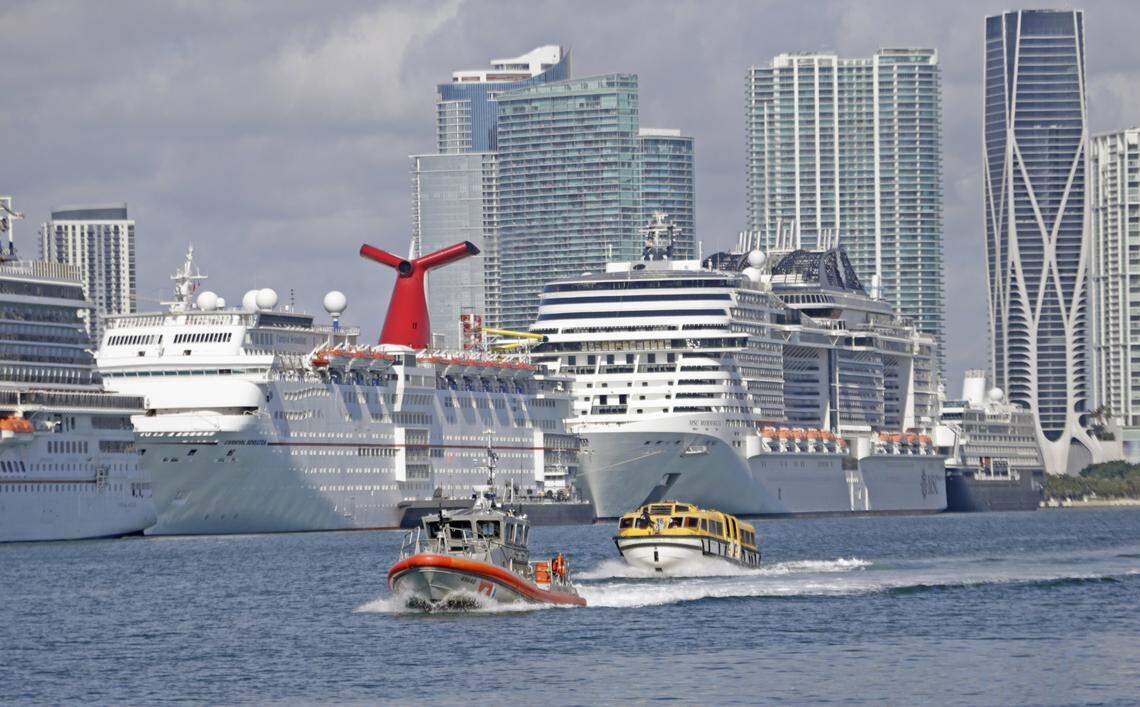 A lifeboat from the Costa Magica cruise ship is escorted by a U.S. Coast Guard vessel after it dropped off crew members at PortMiami on Monday, March 30, 2020. Crew members left on a charter flight to Manila, Philippines, that evening.