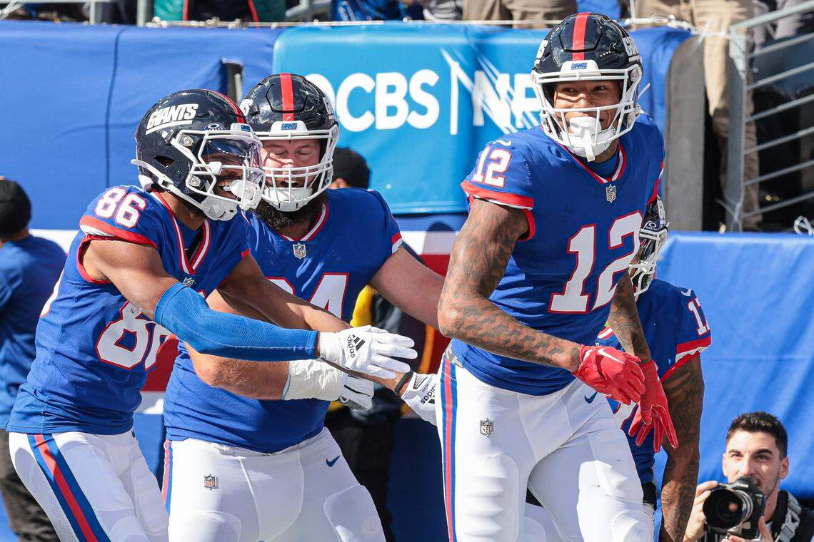 Oct 22, 2023; East Rutherford, New Jersey, USA; New York Giants tight end Darren Waller (12) celebrates his touchdown reception with teammates during the first half against the Washington Commanders at MetLife Stadium. 