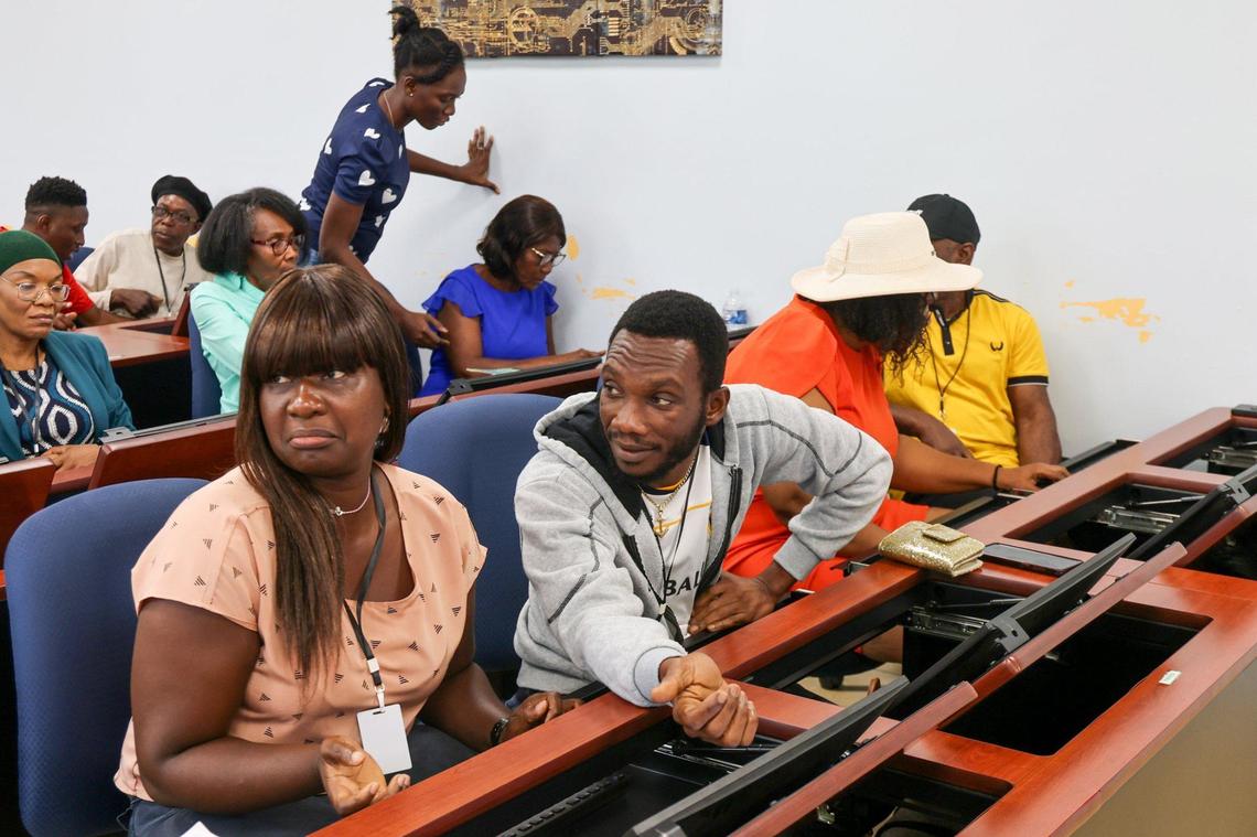Nolcarme Joseph, 36, left, and Franzu Louis- Philippe, 40, center, pay close attention as adult Haitian students attended a computer class at the Pierre Toussaint Leadership and Learning Center in the Little Haiti neighborhood of Miami, Florida, to learn digital skills and ease the pathway into employment on Wednesday, September 25, 2024.