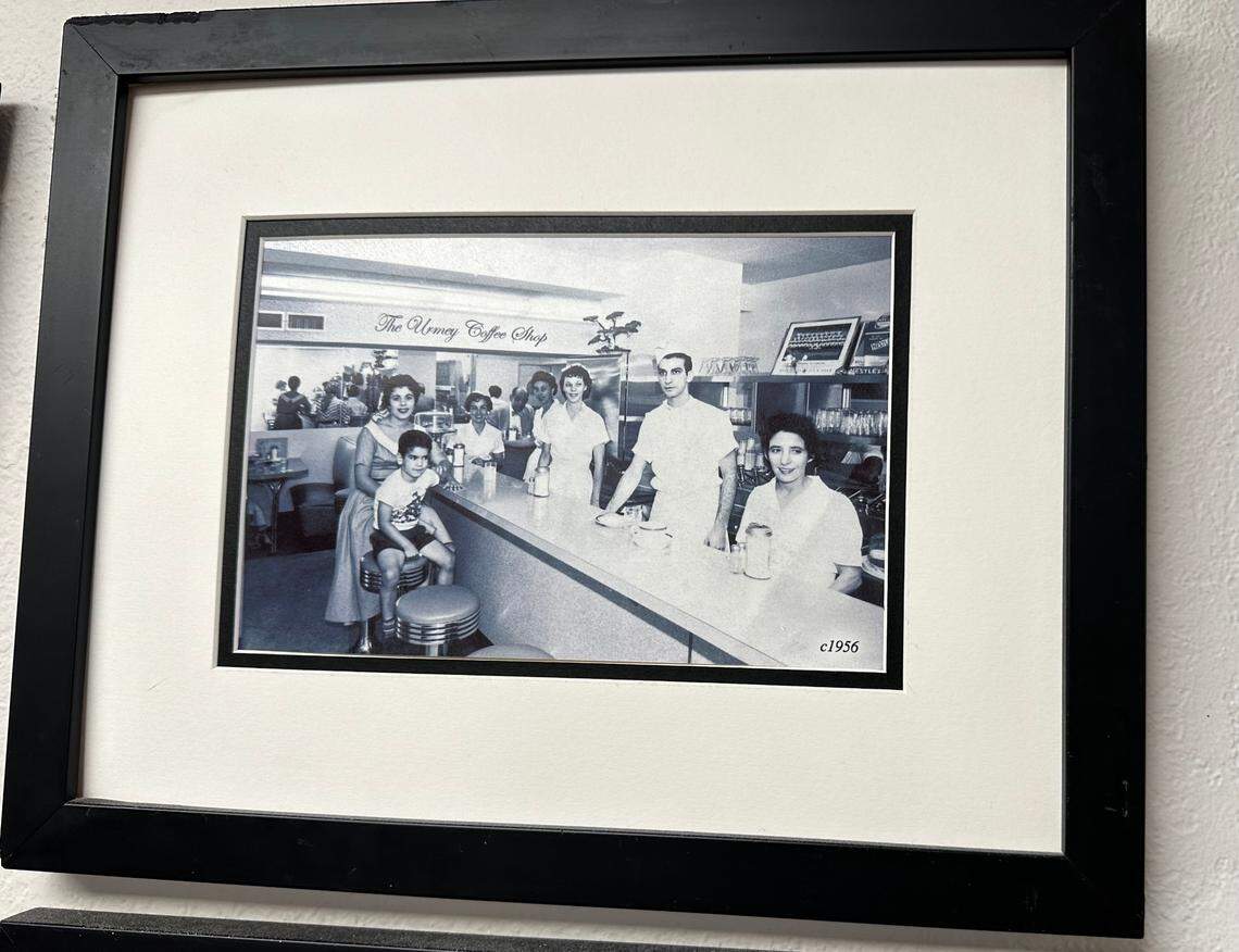 Nick Poulos, then about 5 or 6 in this circa 1956 family photo, is seated on a stool inside The Urmey Coffee Shop in downtown Miami, alongside his parents John and Lula. John Poulos ran the eatery inside the 1917 Urmey Hotel at 34 Southeast Second St. His father James owned the nearby Paramount restaurant. This photo hangs inside Lots of Lox, the deli in the Coral Reef Shopping Center in Palmetto Bay, that the family owns.