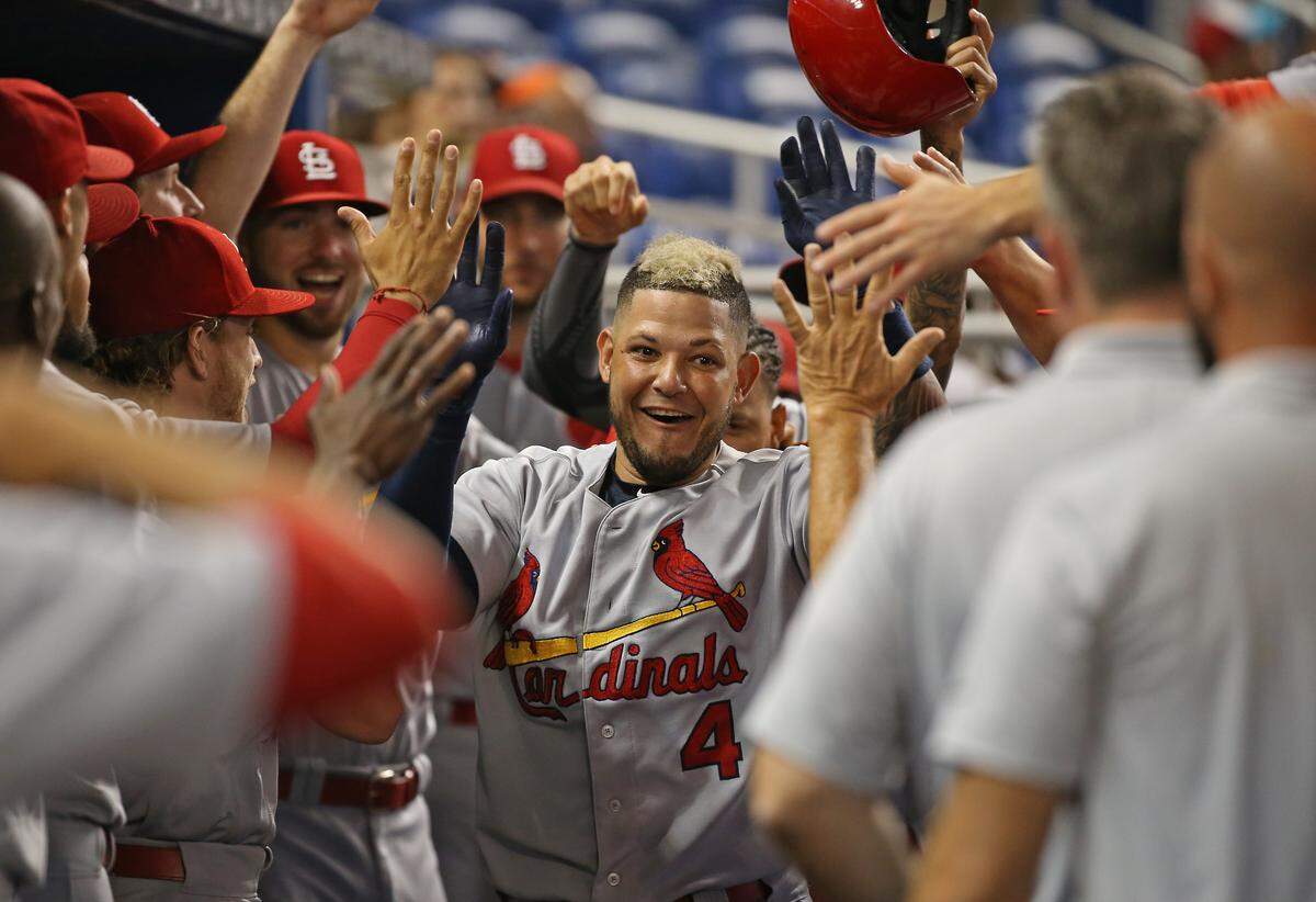 St. Louis Cardinals catcher Yadier Molina is congratulated by teammates after hitting  a solo home run during the first inning of a Major League Baseball game against the Miami Marlins at Marlins Park on Wednesday, August 8, 2018.