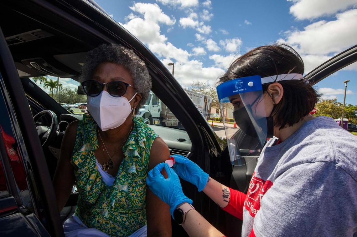 (L) Precilla Butler gets a booster from (R) Yaneisy Rosete of Walgreens during “Stay Well Community Vaccine Event” at the Sweet Home Missionary Baptist Church, in Cutler Bay, on Saturday February 26, 2022.