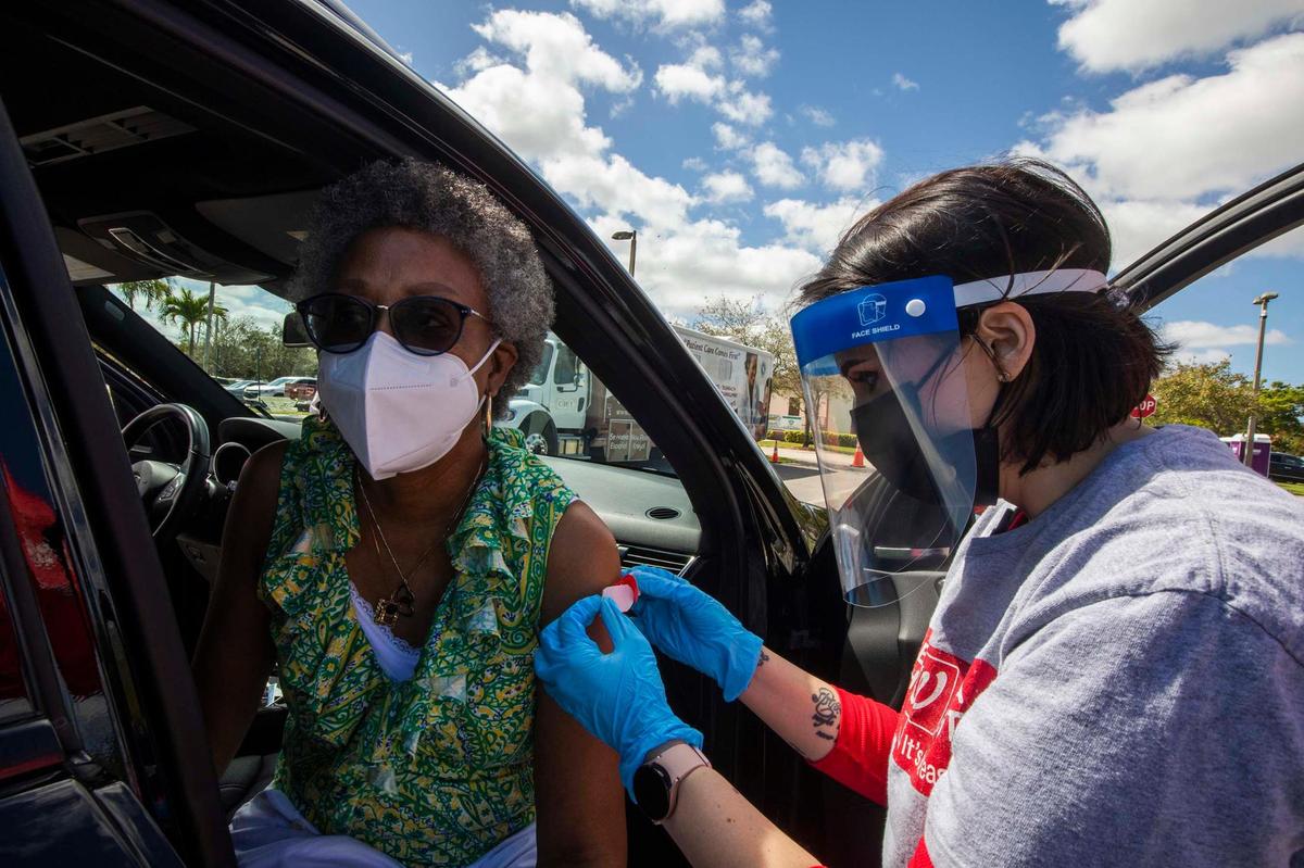 (L) Precilla Butler gets a booster from (R) Yaneisy Rosete of Walgreens during “Stay Well Community Vaccine Event” at the Sweet Home Missionary Baptist Church, in Cutler Bay, on Saturday February 26, 2022.