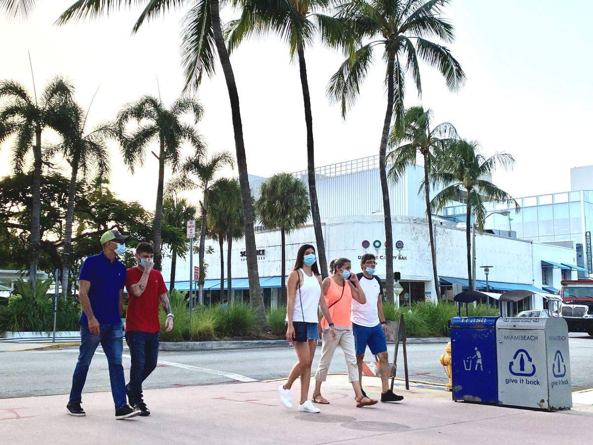 About 40% of people along the Lincoln Road pedestrian mall in Miami Beach had appropriate facial coverings on Friday evening, with about the same number ignoring the mask rule completely.
