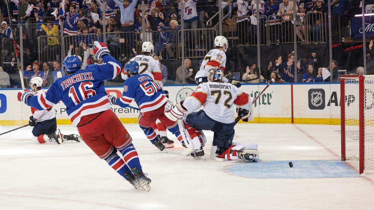 May 24, 2024; New York, New York, USA; New York Rangers center Vincent Trocheck (16) and left wing Will Cuylle (50) celebrate an goal by center Barclay Goodrow (21) against Florida Panthers goaltender Sergei Bobrovsky (72) during overtime in game two of the Eastern Conference Final of the 2024 Stanley Cup Playoffs at Madison Square Garden. Mandatory Credit: Vincent Carchietta-USA TODAY Sports