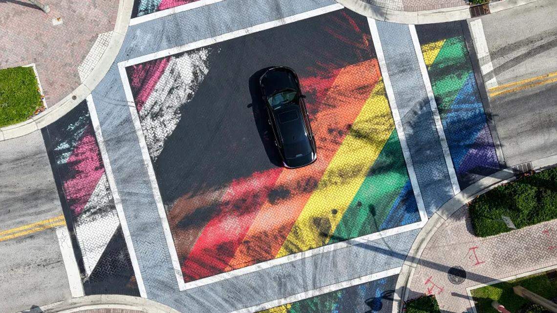 A driver crosses the intersection of Northeast First Street and Northeast Second Avenue in Delray Beach on Tuesday, Sept. 9, 2025. In the morning, passers-by found the rainbow-colored intersection, at the Northeast First Street and Northeast Second Avenue, was only partially covered with black markings.