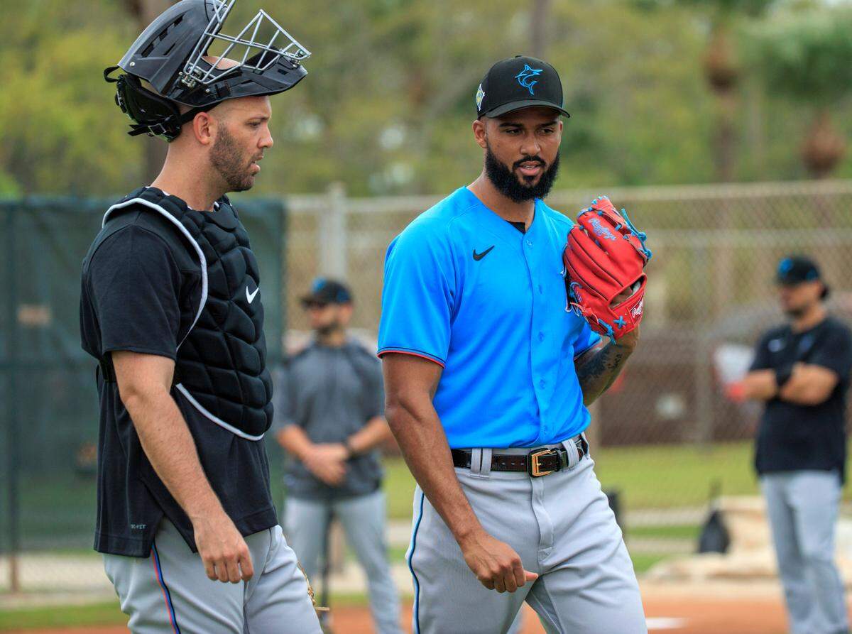 Miami Marlins catcher Jacob Stallings talks with Marlins pitcher Sandy Alcantara during their spring training workout at Roger Dean Stadium on Tuesday, March 15, 2022 in Jupiter, FL.