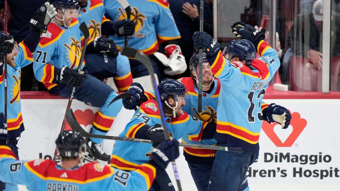 Florida Panthers center Sam Reinhart (13) is mobbed by teammates after he scored during an overtime period of an NHL hockey game to beat the Boston Bruins 4-3, Saturday, Jan. 28, 2023, in Sunrise, Fla. (AP Photo/Wilfredo Lee)