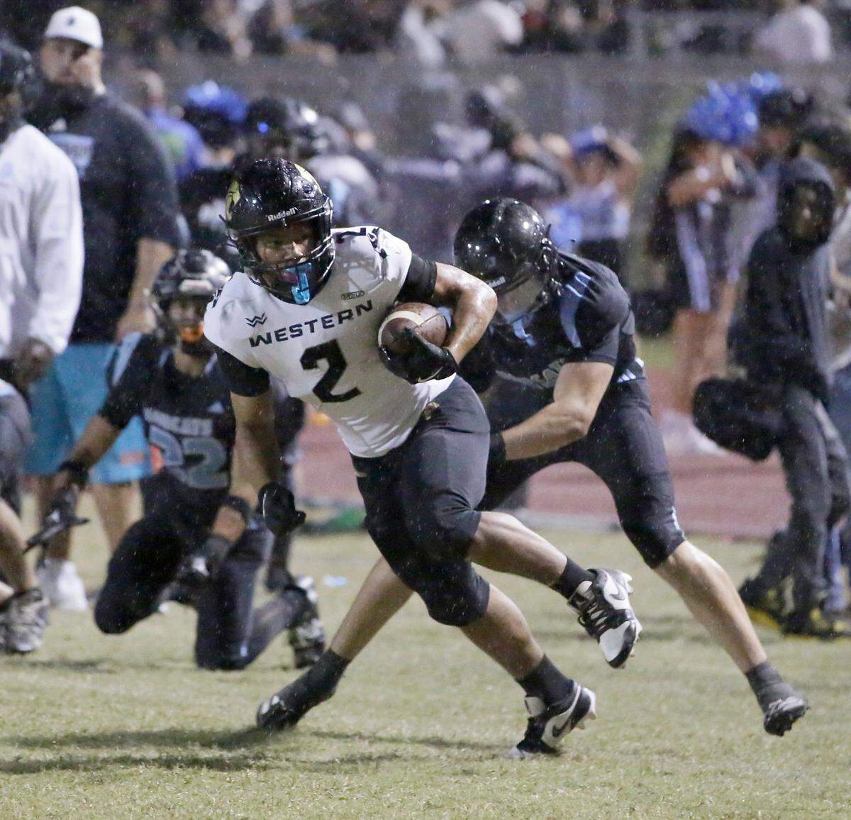 Western Wildcats Johnathan Bueno (2) escapes a tackle by West Broward Bobcats during football game on Friday, November 1, 2024 at Everglades HS in Miramar. Andrew Uloza / for Miami Herald