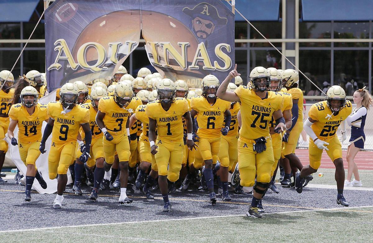 Zion Turner (1) and Julian Armella (75) lead St. Thomas Aquinas on to the field for a game against Baltomore’s St. Frances Academy on Saturday, August 28, 2021 at St. Thomas HS in Fort Lauderdale