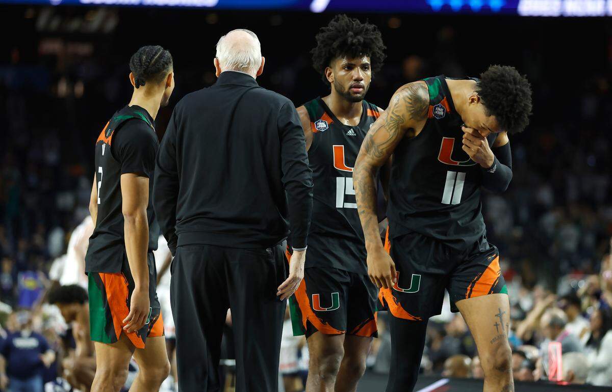 Miami Hurricanes players Jordan Miller (11) Norchad Omier (15) and Isaiah Wong (2) walk by Hurricanes head coach Jim Larranaga looks on during the second half of the Men’s Basketball Championship National Semifinal against the Connecticut Huskies at NRG Stadium in Houston, Texas on Saturday, April 1, 2023.