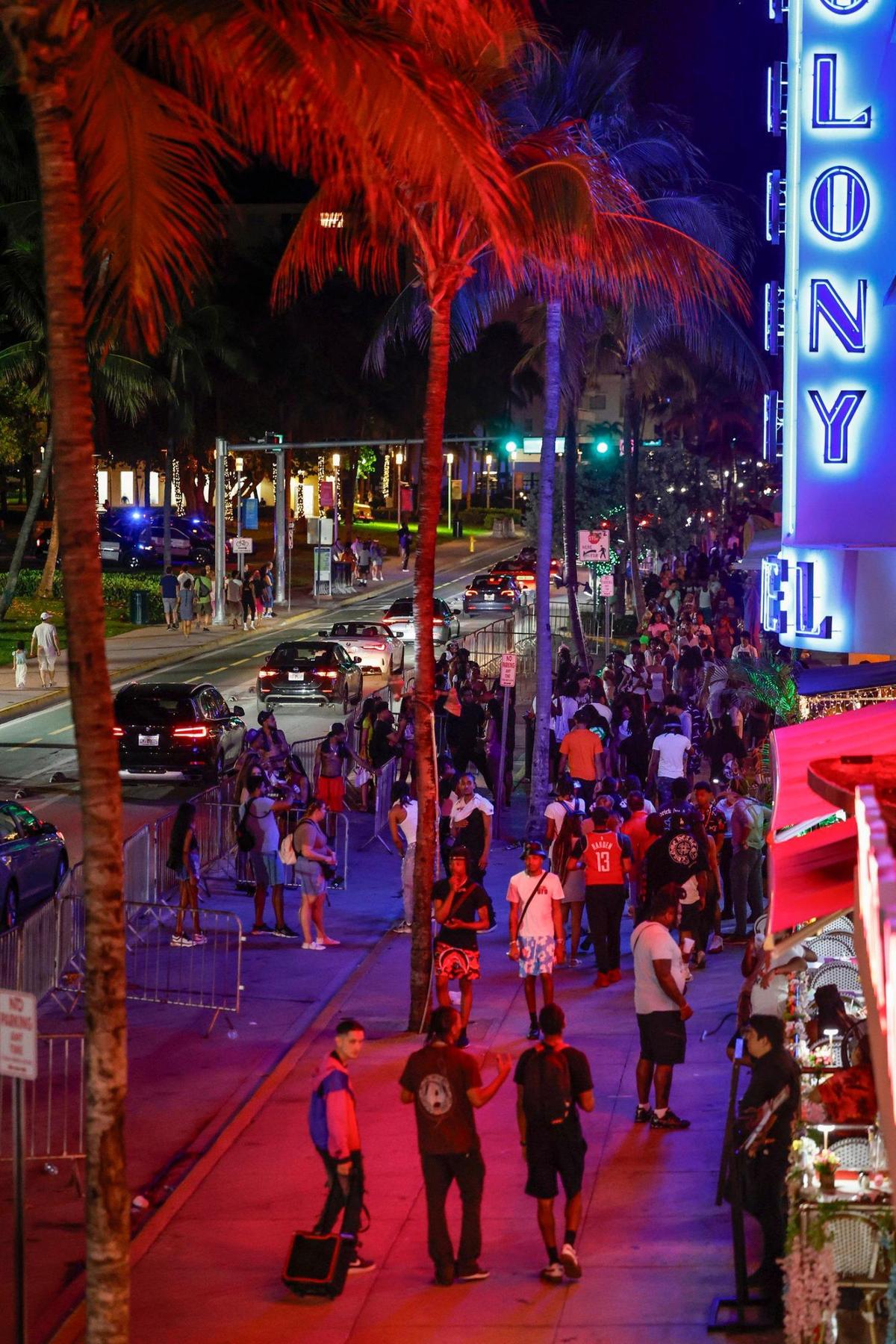 People walk along Ocean Drive during spring break on Miami Beach, Florida on Sunday, March 17, 2024.