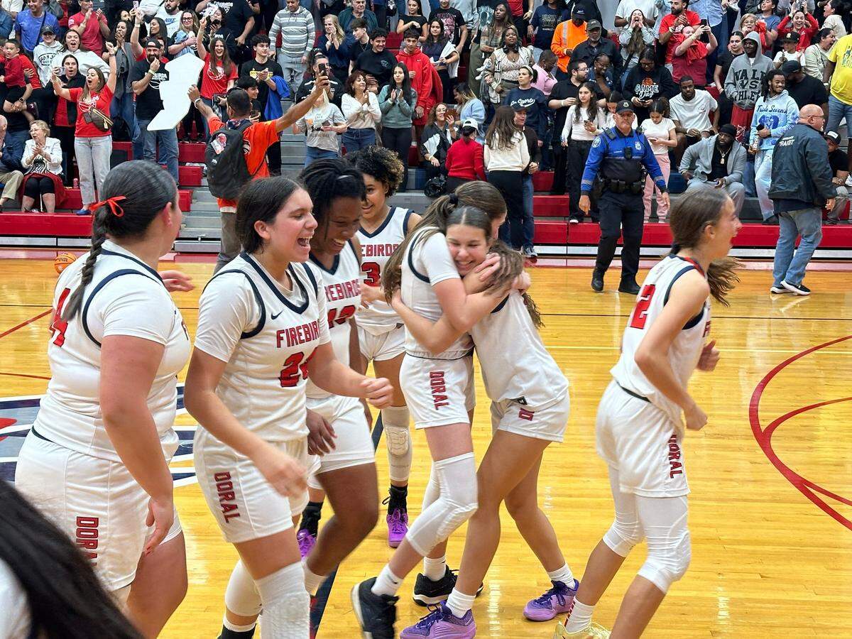 Doral Academy players celebrate after their victory over Miami High in the Region 4-7A girls’ basketball final on Friday at the Firebirds’ gym.