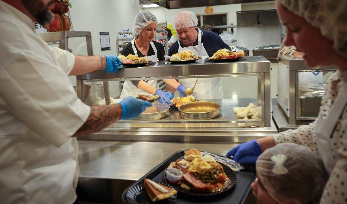 Volunteers serve and distribute meals to more than 400 clients for Thanksgiving.  Camillus House held its 65th annual Thanksgiving Celebration, a cherished tradition that brings hope, dignity, and fellowship to hundreds of individuals experiencing shelter insecurity with a Thanksgiving dinner and other activities at its main campus on Thursday, November 27, 2025, in Miami, Florida. 