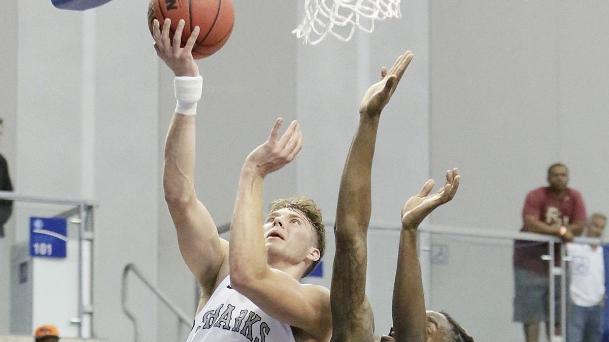 NSU’s Connor Zinaich, left, goes for a shot against Miles Golden Bears on Saturday, March 16, 2019 at Rick Case Arena in Fort Lauderdale. Zinaich had game highs in points (25) and rebounds (nine).