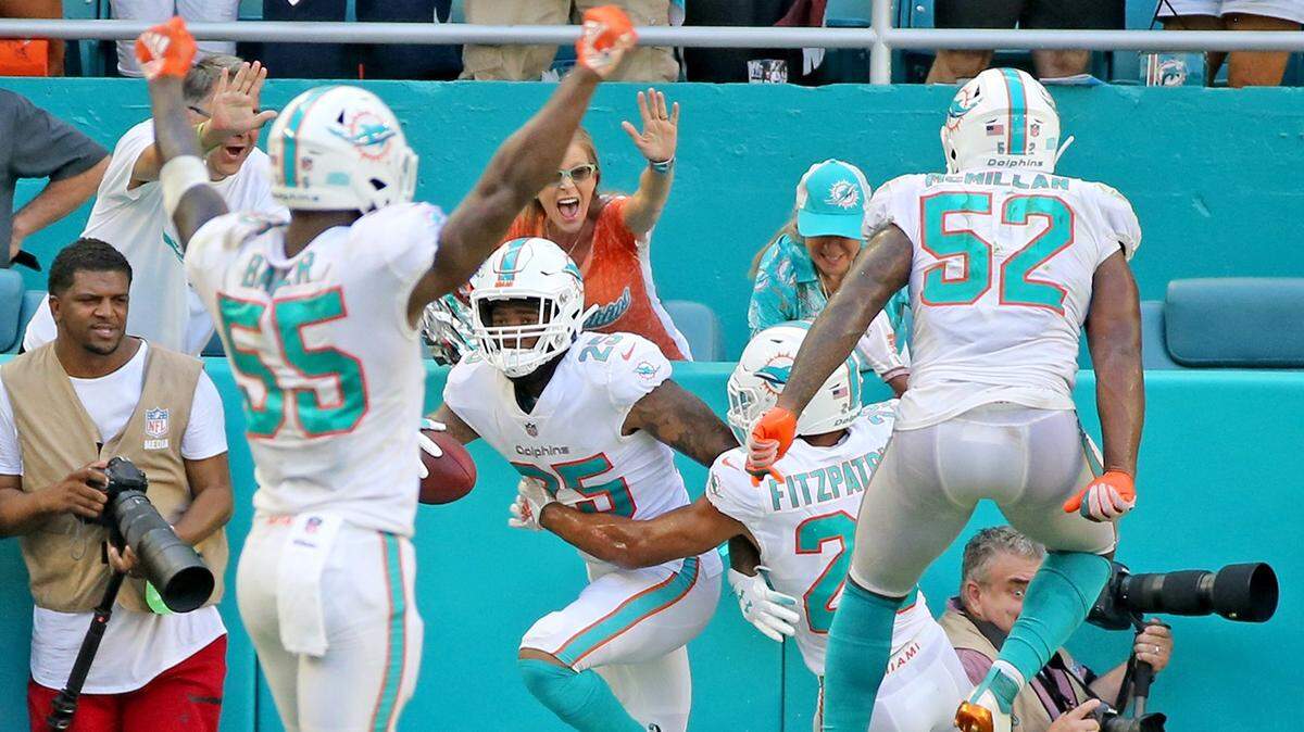 Miami Dolphins cornerback Xavien Howard (25) celebrates with teammates after picking off his second pass of the game Sunday.