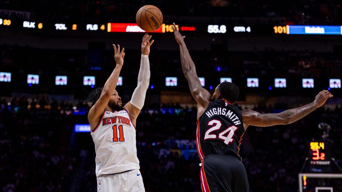 New York Knicks guard Jalen Brunson (11) attempts a three-pointer over Miami Heat forward Haywood Highsmith (24) during the second half of an NBA game on March 2, 2025, in Miami.