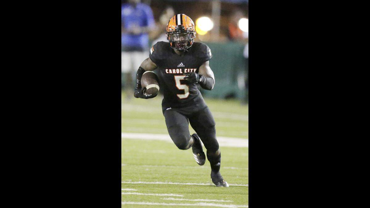 In this Oct. 12, 2018, file photo, Carol City Chiefs running back Nay’quan Wright (5) runs upfield against the Northwestern Bulls at Traz Powell stadium in Miami