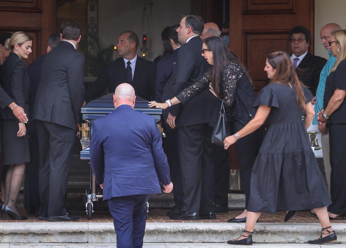 Family members and friends reach to touch the casket of Marcus Guara, 52. The Burial Mass was held for the four members of the Guara family -- Marcus Guara, 52, Anaely Rodriguez, 42, and their two daughters - Lucia Guara, 10, Emma Guara, 4, at St. Joseph Catholic Church in Miami Beach, Florida Tuesday, July 6, 2021. The family was killed in the collapse of Champlain Towers South condo building on June 24, 2021.