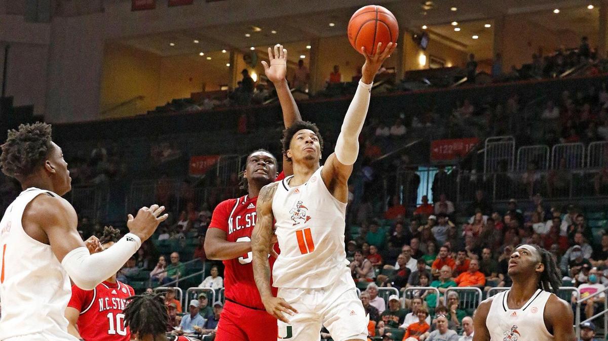 UM Hurricanes Jordan Miller (11) goes up for a shot against NC State Wolfpack during basketball game on Saturday, December 10, 2022 at Watsco Center in Coral Gables. Andrew Uloza / for Miami Herald