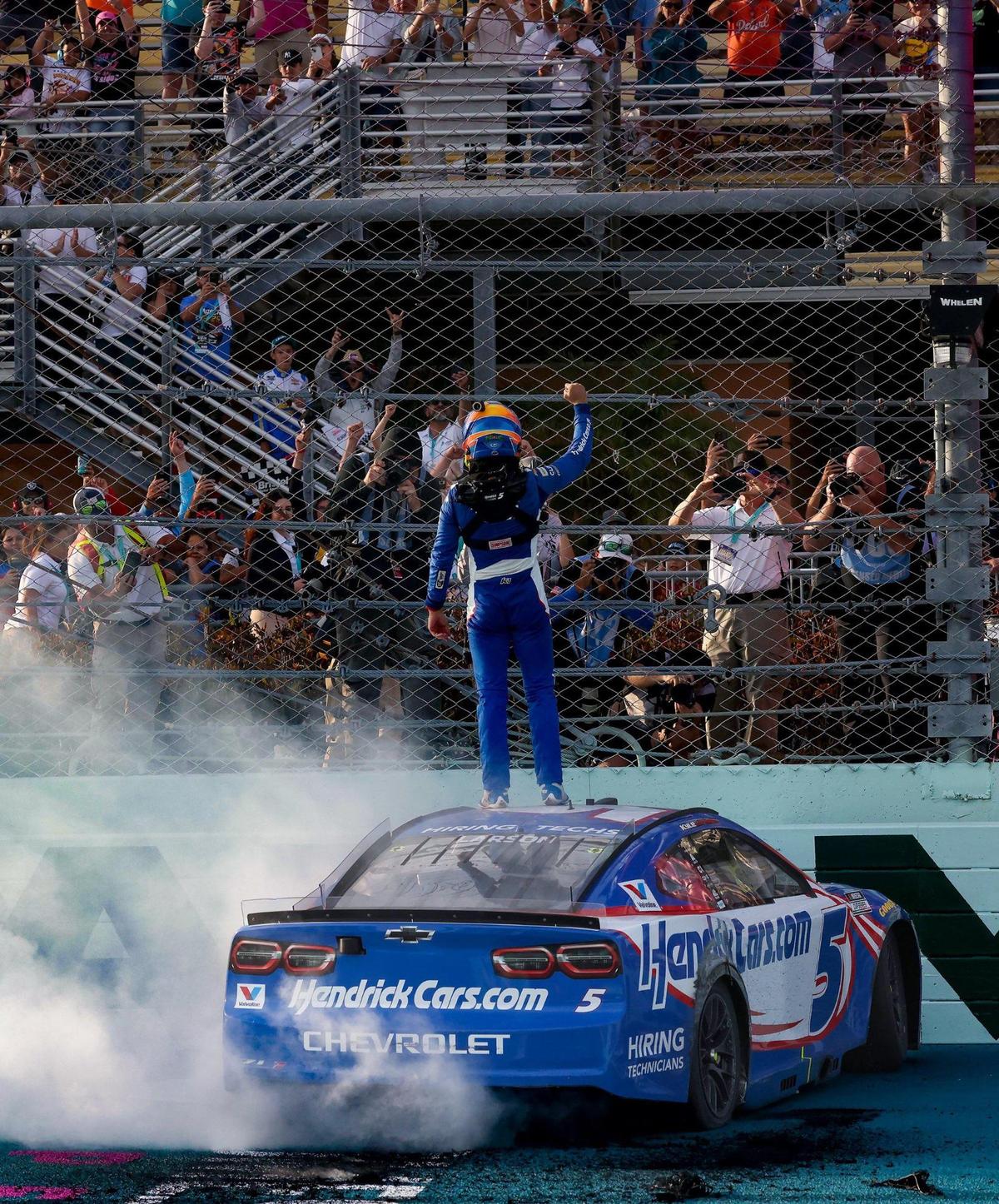 Kyle Larson (5) celebrates with fans after winning the Straight Talk Wireless 400 NASCAR Cup Series race on Sunday, March 23, 2025, at the Homestead-Miami Speedway in Homestead, Fla.