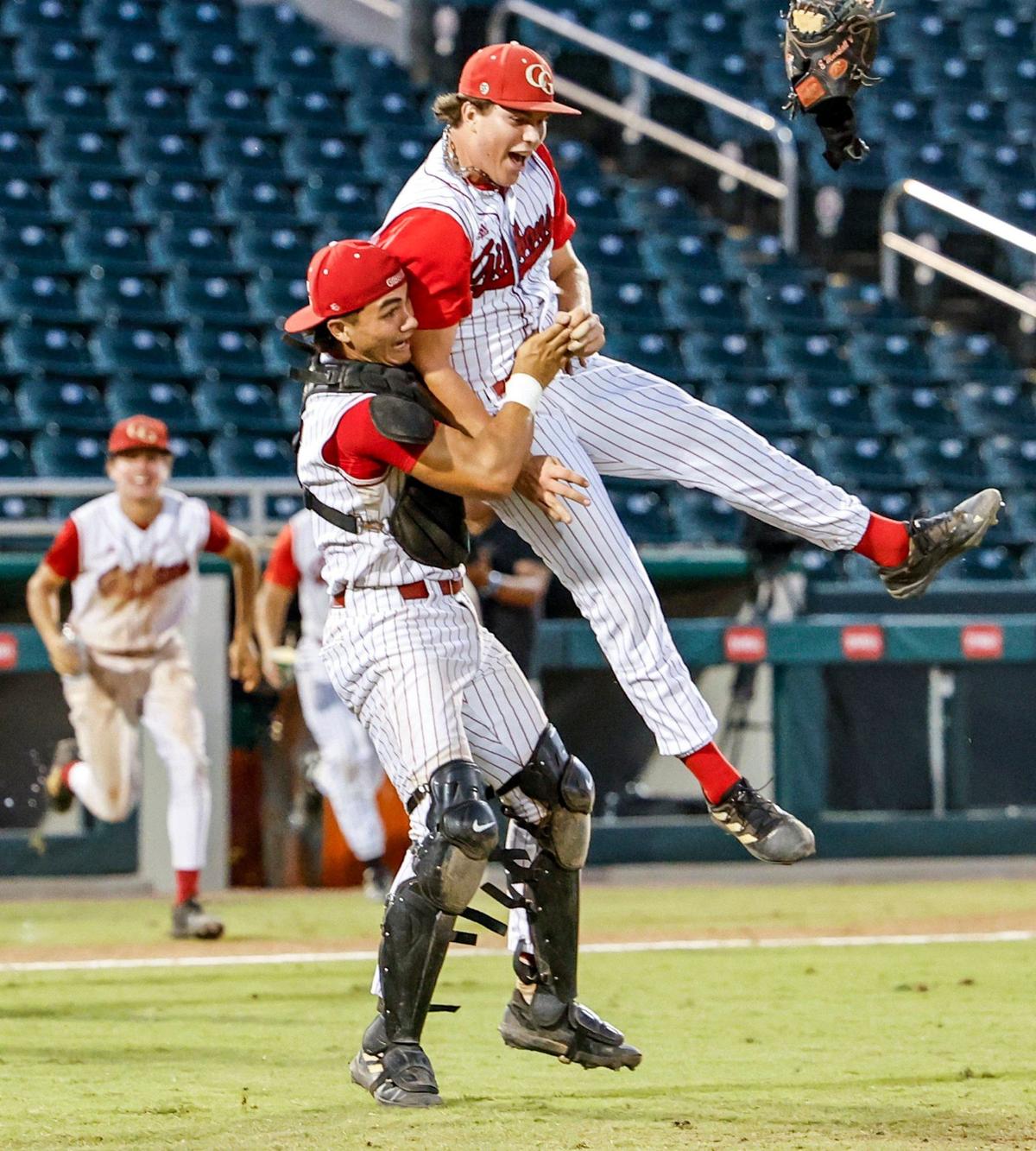 Cardinal Gibbons Chiefs catcher Eddie Marshall (5) lifts pitcher Brenden Trujillo (25) as they celebrate the win against the South Walton Seahawks for the FHSAA Baseball Class 4A State Final at Hammond Stadium in Fort Myers, Florida on Wednesday, May 22, 2024.