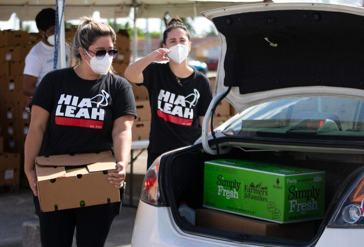 City of Hialeah employees loading up food and vegetables to hundreds of cars lined up for hours early during a drive-thru food distribution at the Goodlet Park, 4200 West Eighth Ave. in Hialeah on Wednesday, July 29, 2020. The City of Hialeah in partnership with Feeding South Florida organized the drive-thru food distribution.