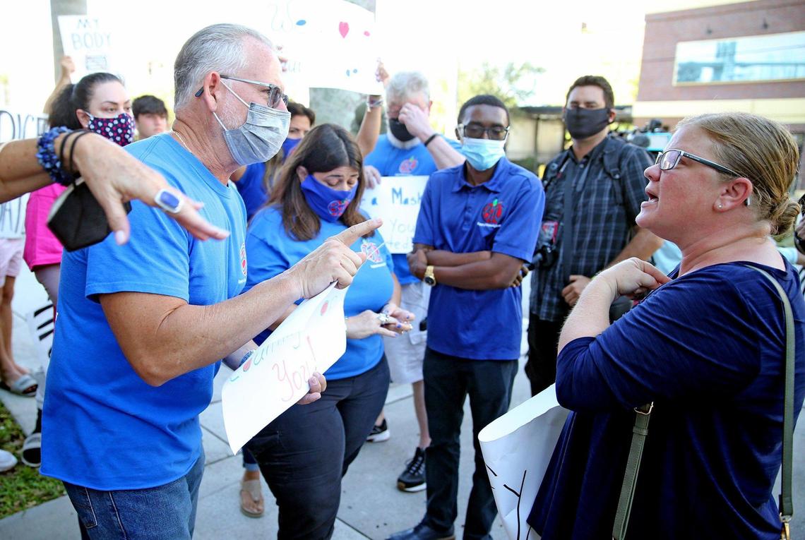 Pro-mask supporter Kenny Minchu and anti-mask supporter Deidre Ruth argue outside while inside the Broward County School Board holds a hearing to determine if it will impose a mask mandate for the upcoming school year. The meeting was in Fort Lauderdale on Aug. 10, 2021.