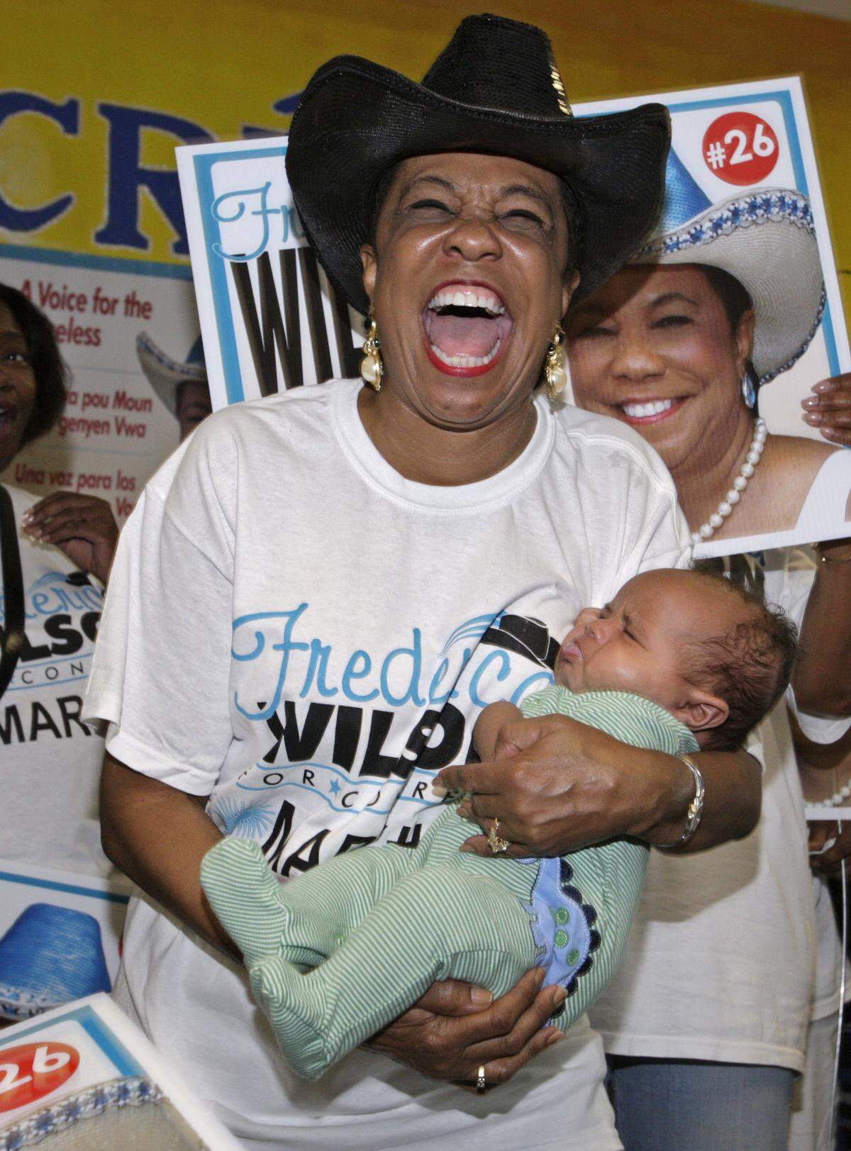 Frederica Wilson holds her 3-month-old grandson Trent Wilson as she celebrates with supporters at The Chef Creole Seasoned Kitchen on Tuesday, Aug. 24, 2010.
