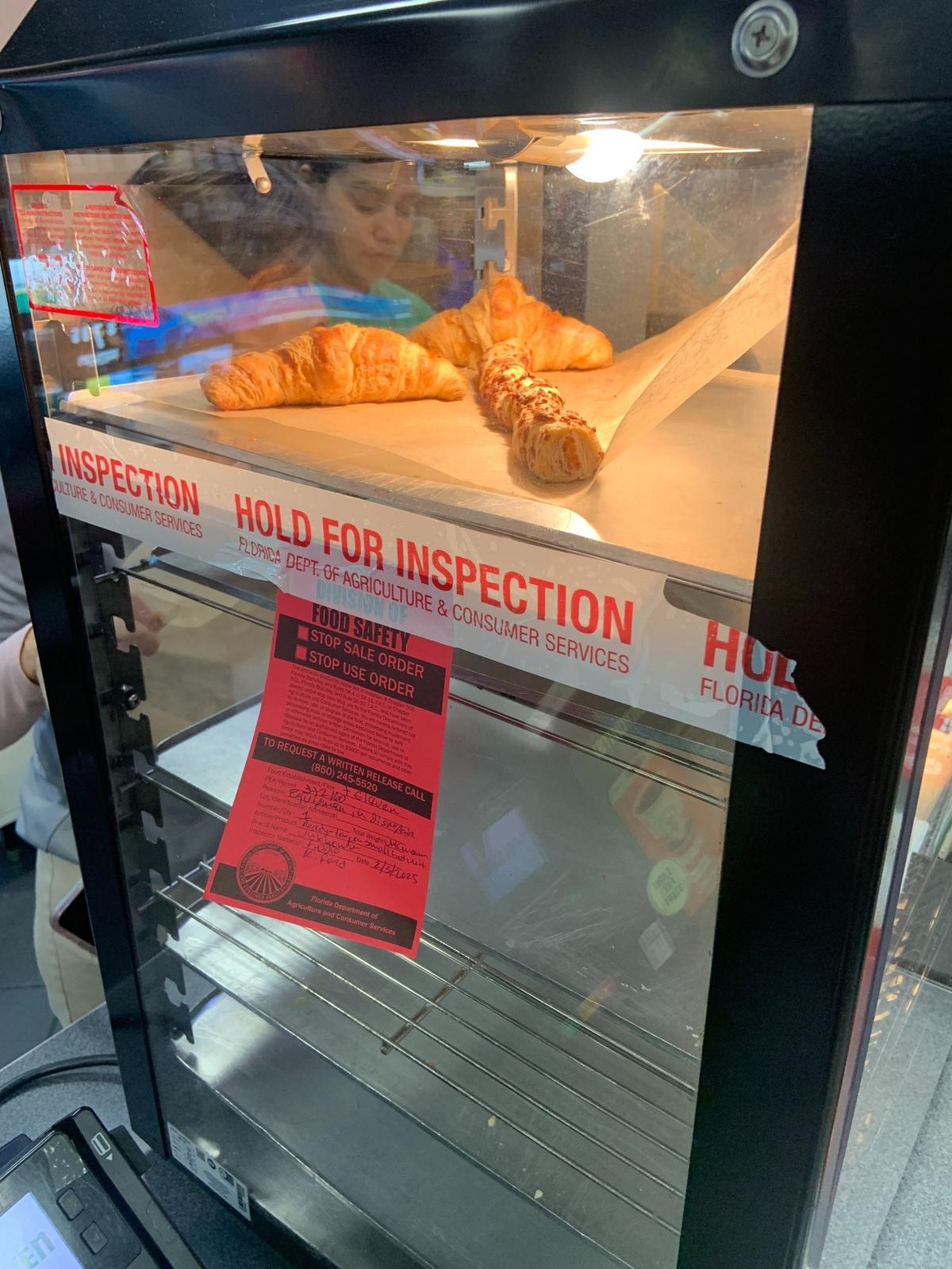 This hot holding unit at the Country Club of Miami area 7-Eleven is under a Stop Use Order but appears to be in use.