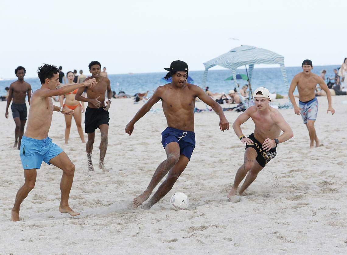 Young people play soccer on the beach during spring break weekend, March 14, 2026 in Miami Beach. 