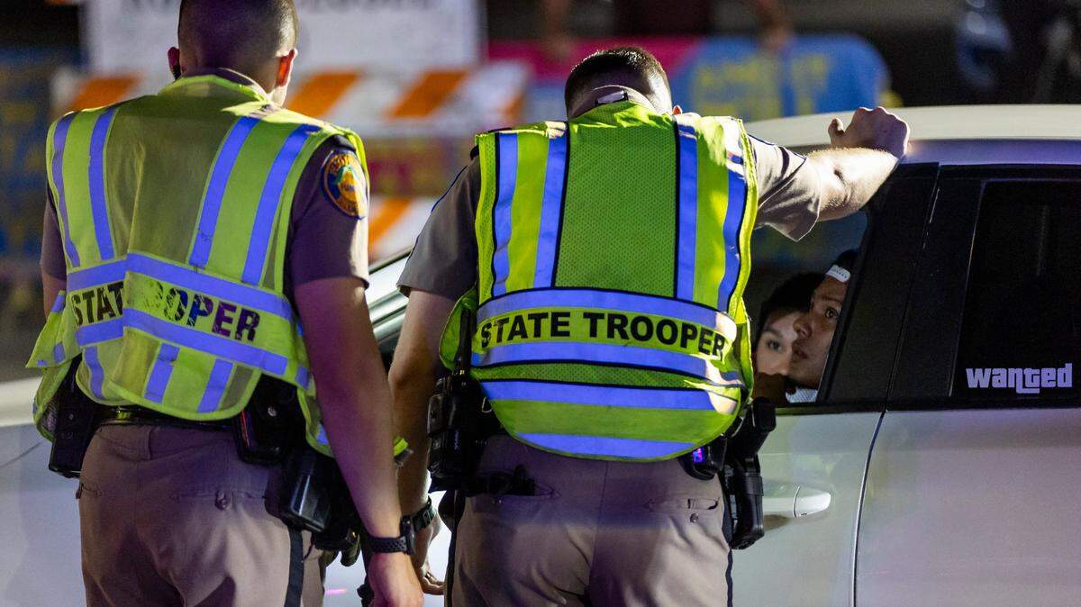 Florida Highway Patrol officers talk to a driver at a DUI checkpoint near 5th Street and Meridian during spring break on Friday, March 8, 2024, in Miami Beach, Fla.
