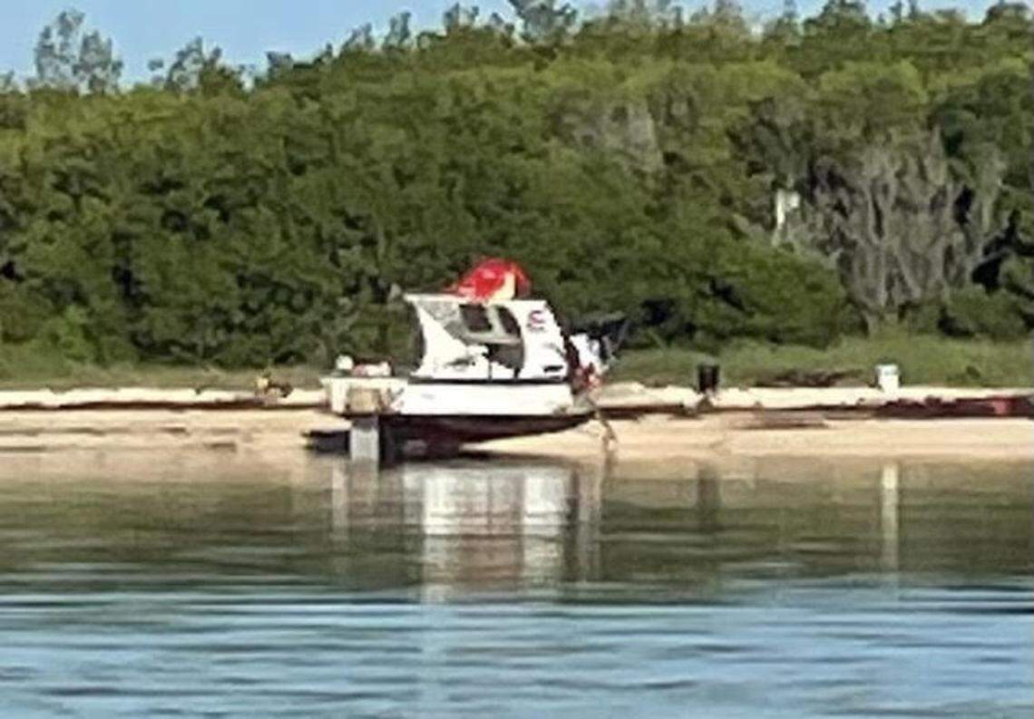 A wooden fishing boat is beached on an island in the Marquesas, located about 20 miles west of Key West, Tuesday, Aug. 16, 2022. The Border Patrol says 22 Cuban migrants were on board the boat.